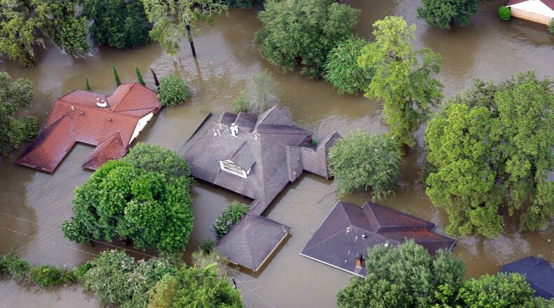 Homes are surrounded by floodwaters from Tropical Storm Harvey Tuesday, Aug. 29, 2017, in Spring, Texas. (AP Photo/David J. Phillip)