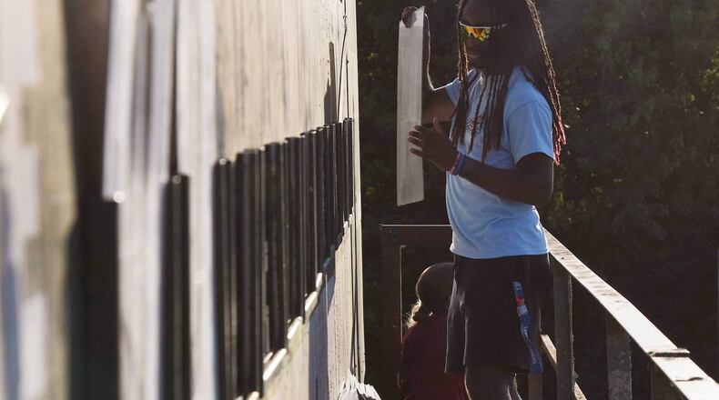 Luther Williams Field scoreboard operator Christian Kendrick changes the score on the manual scoreboard during the Macon Bacon game against Catawba Valley Stars on Tuesday, June 25, 2024, in Macon, Georgia. Luther Williams Field saw extensive renovations in 2018, but the scoreboard remains the original from the park’s opening in 1929. (Photo Courtesy of Katie Tucker/The Telegraph)