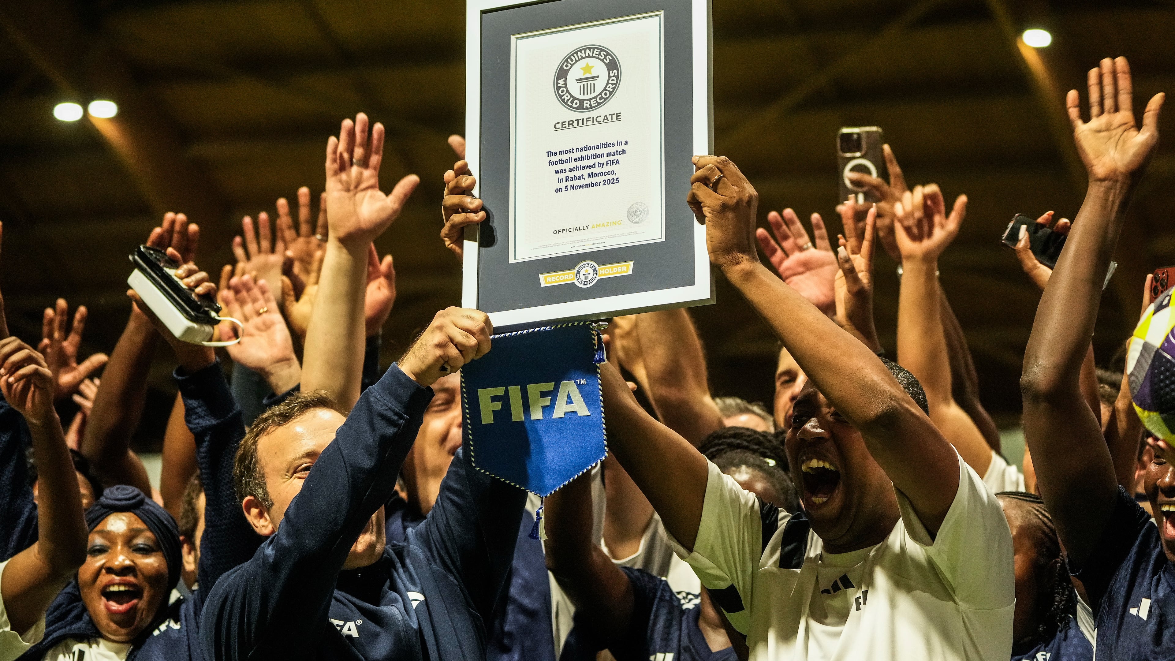 People celebrate after breaking the Guinness World Record for most nationalities in an exhibition soccer match organized by FIFA, in Rabat, Morocco, Wednesday, Nov. 5, 2025. (AP Photo/Mosa'ab Elshamy)