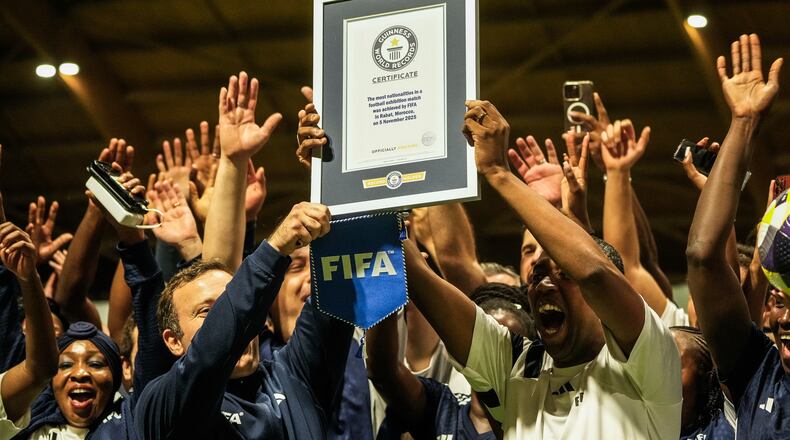 People celebrate after breaking the Guinness World Record for most nationalities in an exhibition soccer match organized by FIFA, in Rabat, Morocco, Wednesday, Nov. 5, 2025. (AP Photo/Mosa'ab Elshamy)