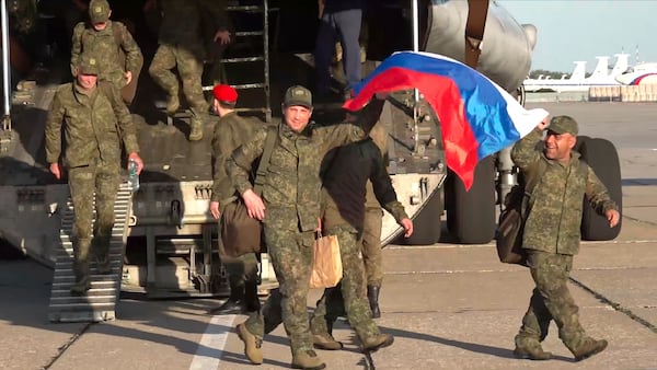 In this photo taken from video released by Russian Defense Ministry Press Service on Saturday, May 24, 2025, Russian servicemen leave a plane upon arrival to Chkalovsky airport, outside Moscow, Russia, after returning from captivity by a POWs exchange between Russia and Ukraine. (Russian Defense Ministry Press Service photo via AP)