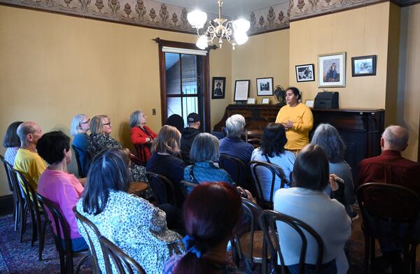 Guide associate Lesley Le Platte greets guests before she leads a tour at the Wren’s Nest in Atlanta on Saturday, March 21, 2026. (Hyosub Shin/AJC)