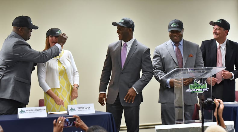 From left, Zeric Foster, COO of Atlanta Sports Connection, Trish Edge, manger of Stonecrest Mall, Patrick Henderson, CEO of Atlanta Sports Connection, Vaughn Irons, Principal of  Atlanta Partners for Development, and Scott Boden, chief medical offer at Emory Univ. Orthopaedics  and Spine Center, celebrate during a press conference on Wednesday, May 17, 2017. Developers and tourism officials revealed plans for medical facilities and retail at Atlanta Sports City. HYOSUB SHIN / HSHIN@AJC.COM