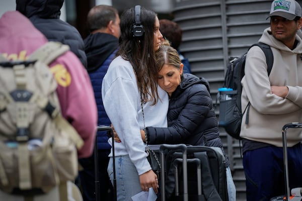 Travelers wait for news about their delayed trains at the Madrid train station, Spain, Monday, May 5, 2025. (AP Photo/Manu Fernandez)