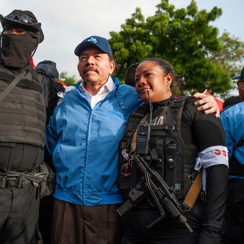 FILE - Nicaraguan police have their picture taken with President Daniel Ortega, in Masaya, Nicaragua, July 13, 2018. (AP Photo/Cristobal Venegas, File)