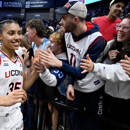 UConn guard Azzi Fudd (35) slaps hands with students at the end of a game against Syracuse in the second round of the NCAA college basketball tournament, Monday, March 23, 2026, in Storrs, Conn. (AP Photo/Jessica Hill)