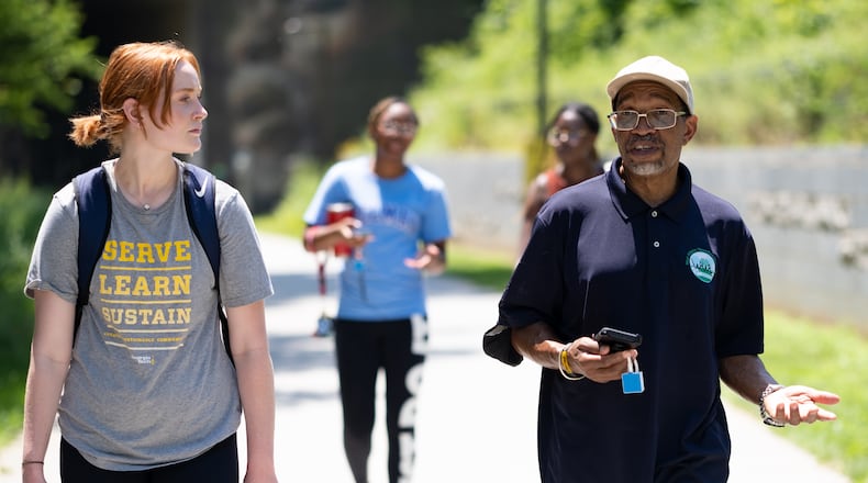 Georgia Tech student Meg Sanders, left, talks with Darryl Haddock, director of environmental education for the West Atlanta Watershed Alliance, as they use a device and app to map temperature data while walking on the Westside Beltline on Wednesday, June 15, 2022. (Ben Gray for the Atlanta Journal-Constitution)