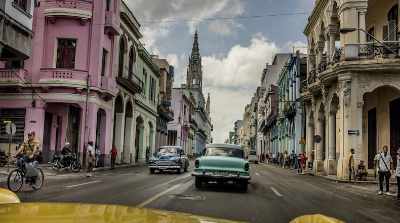 FILE â Vintage cars cruise a street in Havana, Cuba, Jan. 2016. The author Reif Larsen says âNo one can predict what will happen to Cuba in the coming years, which is why you must rush there now. As in, right now.â (Tomas Munita/The New York Times) -- NO SALES