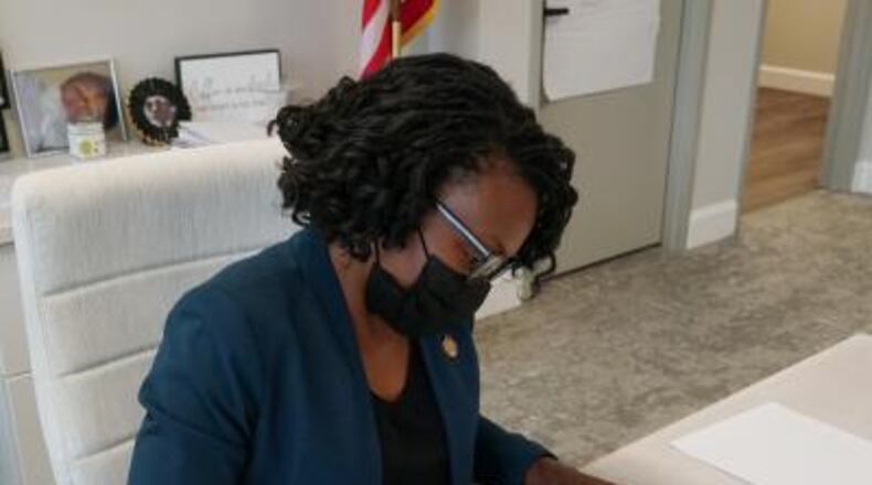 Cobb County Chairwoman Lisa Cupid signs an order declaring the county in a State of Emergency due to the latest surge in COVID-19 cases on Thursday, Aug. 19, 2021. (Photo courtesy of Cobb County)