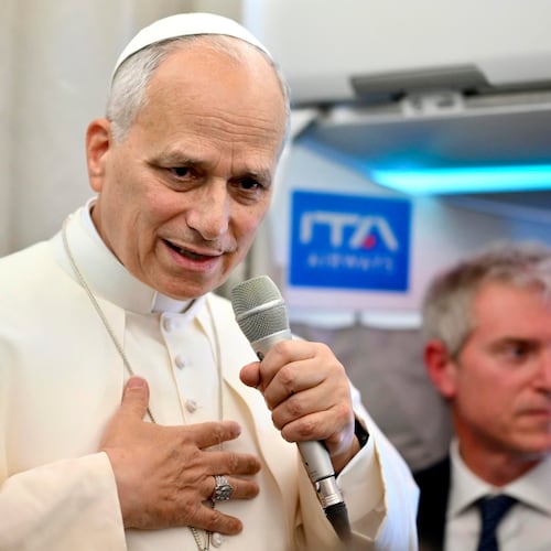 Pope Leo XIV talks to reporters aboard an airplane as he returns from a six-day visit to Turkey and Lebanon, Tuesday, Dec. 2, 2025. (Alessandro Di Meo/Pool Photo via AP)