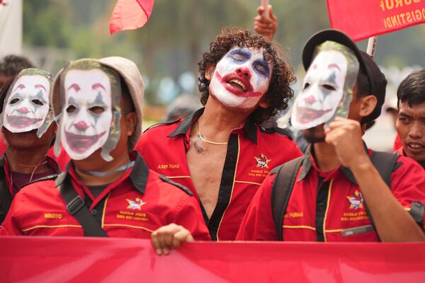 A laborer with the face painted as the Joker chants slogans during a May Day rally in Jakarta, Indonesia Thursday, May 1, 2025. (AP Photo/Tatan Syuflana)
