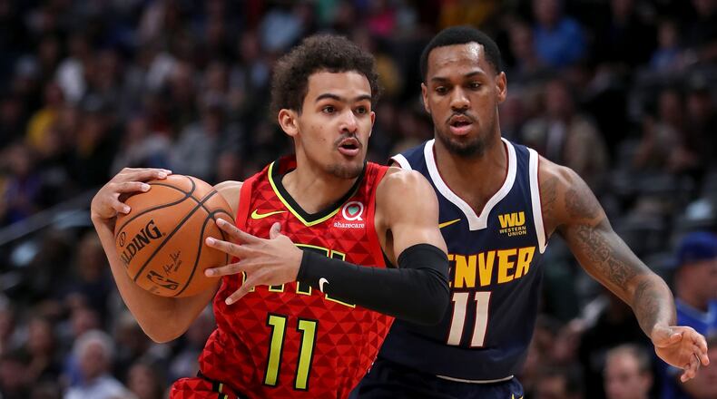 Trae Young of the Atlanta Hawks drives to the basket against Monte Morris of the Denver Nuggets.