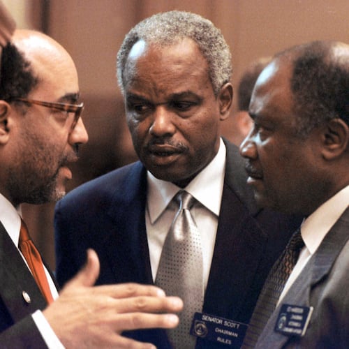 Georgia Congressman David Scott (center) confers with fellow lawmakers at the state Capitol in 2000. (Alan Mothner/AP)