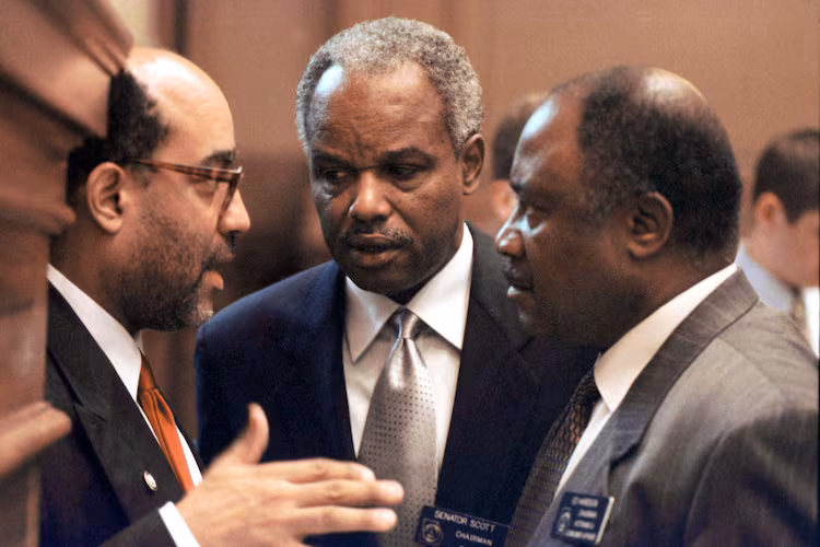 Georgia Congressman David Scott (center) confers with fellow lawmakers at the state Capitol in 2000. (Alan Mothner/AP)