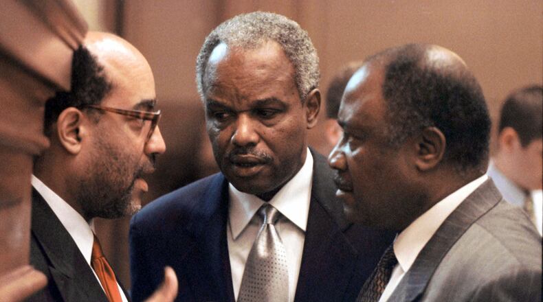 Georgia Congressman David Scott (center) confers with fellow lawmakers at the state Capitol in 2000. (Alan Mothner/AP)