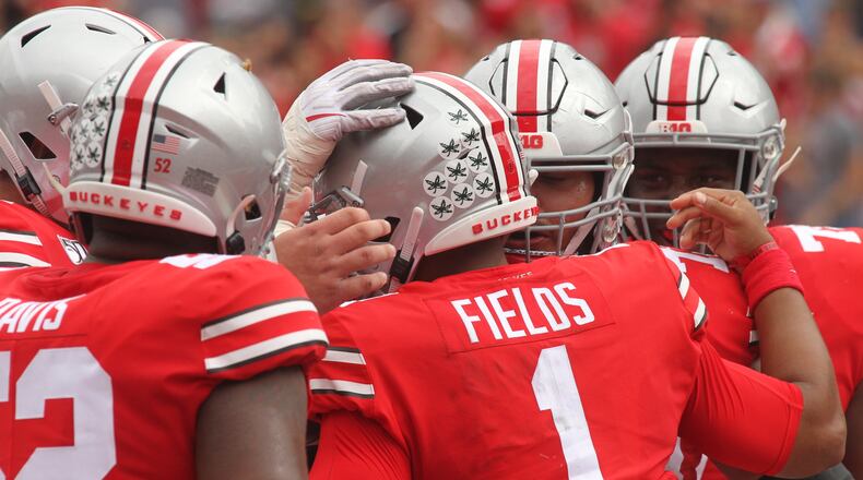 Justin Fields and the Buckeyes celebrate during the first half of their game against Cincinnati on Saturday, Sept. 7, 2019, in Columbus, Ohio.