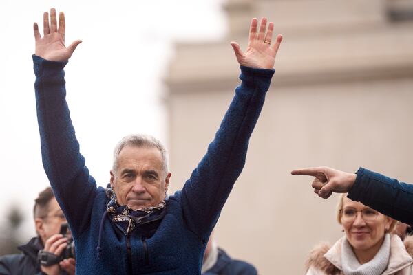 FILE - Calin Georgescu, the winner of the first round of presidential elections, later annulled by the Constitutional Court, waves to supporters during a protest, in Bucharest, Romania, March 1, 2025. (AP Photo/Vadim Ghirda, File)