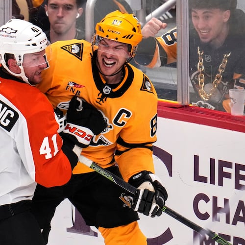 Pittsburgh Penguins' Sidney Crosby, right, is defended by Philadelphia Flyers' Luke Glendening (41) during the third period of Game 5 in the first round of an NHL hockey Stanley Cup playoff series in Pittsburgh, Monday, April 27, 2026. (AP Photo/Gene J. Puskar)