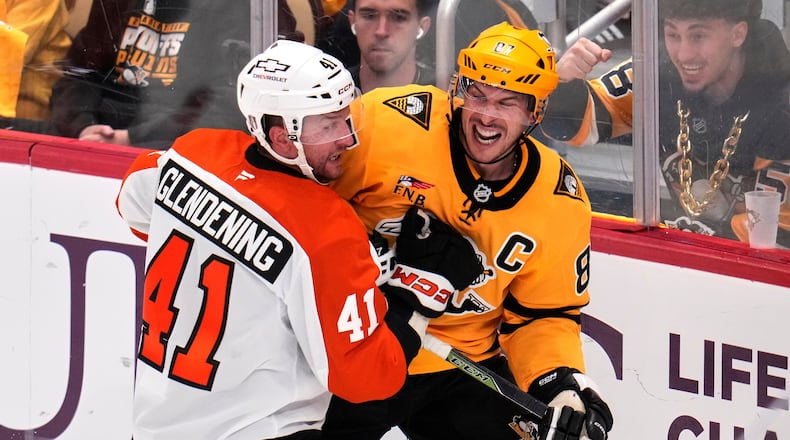 Pittsburgh Penguins' Sidney Crosby, right, is defended by Philadelphia Flyers' Luke Glendening (41) during the third period of Game 5 in the first round of an NHL hockey Stanley Cup playoff series in Pittsburgh, Monday, April 27, 2026. (AP Photo/Gene J. Puskar)