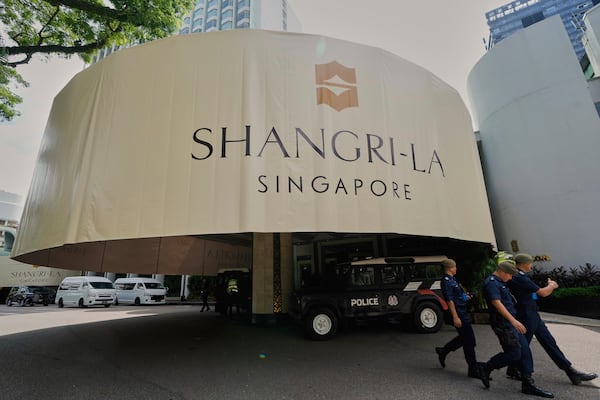 Police officials walk past the venue during the Shangri-La Dialogue summit in Singapore, Friday, May 30, 2025. (AP Photo/Anupam Nath)
