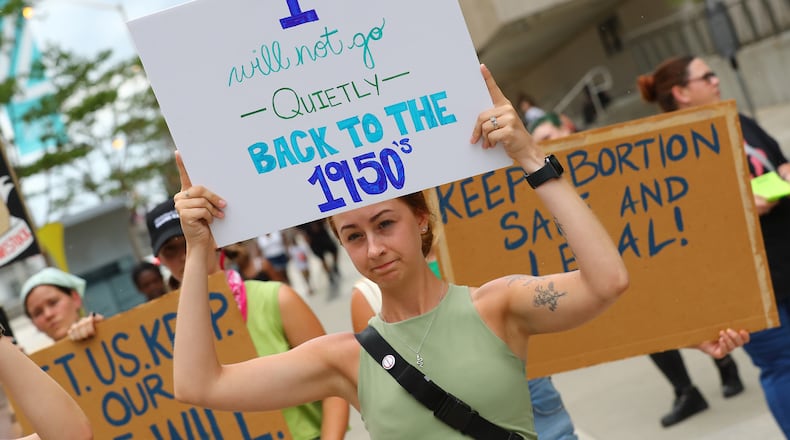 Protesters hold their signs during an abortion rights rally led by members of RiseUp4AbortionRights.org at CNN Center in Atlanta on Sunday, July 3, 2022. (Curtis Compton / Curtis.Compton@ajc.com)