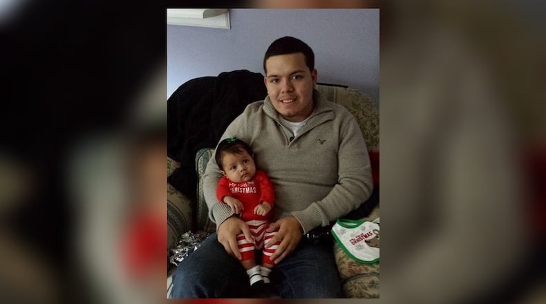Daniel Perez, pictured with his son, was shot while sitting in a pickup truck Friday. The 25-year-old's family says he is brain dead.