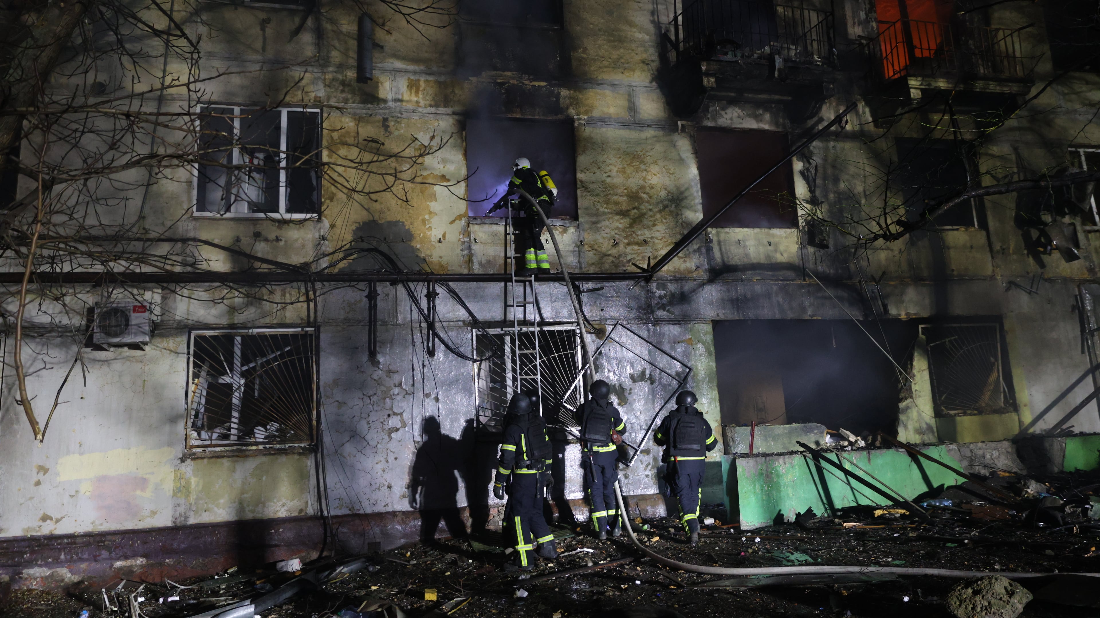 Rescue workers try to put out a fire of residential building burning after a Russian attack on Zaporizhzhia, Ukraine, Wednesday, Nov. 26, 2025. (AP Photo/Kateryna Klochko)
