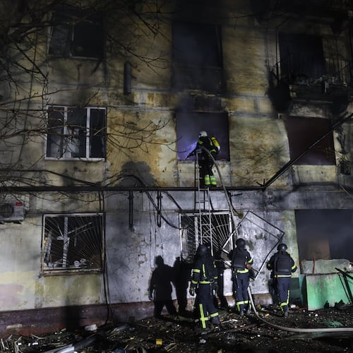 Rescue workers try to put out a fire of residential building burning after a Russian attack on Zaporizhzhia, Ukraine, Wednesday, Nov. 26, 2025. (AP Photo/Kateryna Klochko)