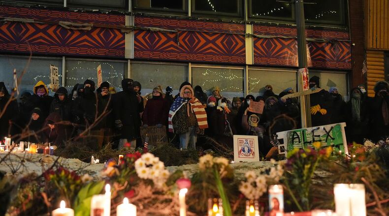 FILE - People gather during a vigil for 37-year-old Alex Pretti, who was fatally shot by a U.S. Border Patrol officer earlier in the day, Jan. 24, 2026, in Minneapolis. (AP Photo/Adam Gray, File)