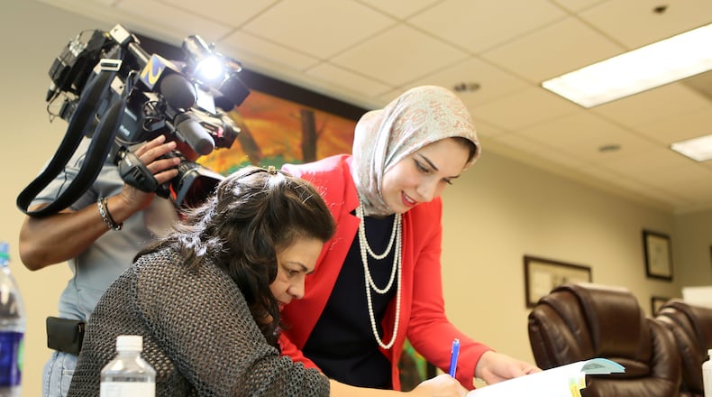 March 8, Fulton County.  Elizabeth Hernandez-Carrillo signs paperwork with her lawyer. Carrillo was released after spending a month at a south Georgia detention center. Miguel Martinez/Mundo Hispanico