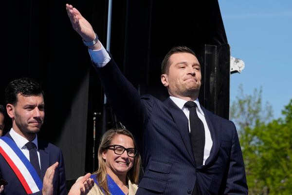 The leader of France's National Rally (RN) Jordan Bardella arrives as he attends at the French far-right party national rally near the parliament in support of Marine Le Pen in Paris, Sunday, April 6, 2025. (AP Photo/Michel Euler)