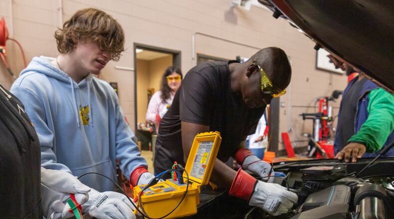Luke Castle and Bob Jones perform a diagnostic test on the engine of a car at Savannah Technical College on Tuesday, July 16, 2024. (AJC Photo/Katelyn Myrick)