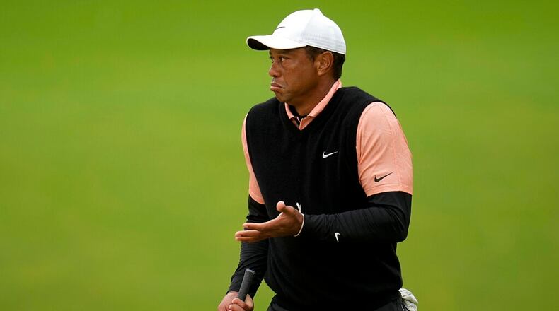 Tiger Woods gestures on the green at the 17th hole during the third round of the PGA Championship golf tournament at Southern Hills Country Club, Saturday, May 21, 2022, in Tulsa, Okla. (AP Photo/Sue Ogrocki)