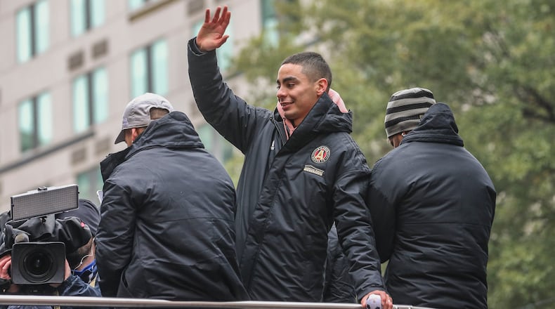 Miguel Almiron waves to the crowds who took to the streets of downtown Atlanta in celebration of Atlanta United's MLS Cup championship. (John Spink/jspink@ajc.com)