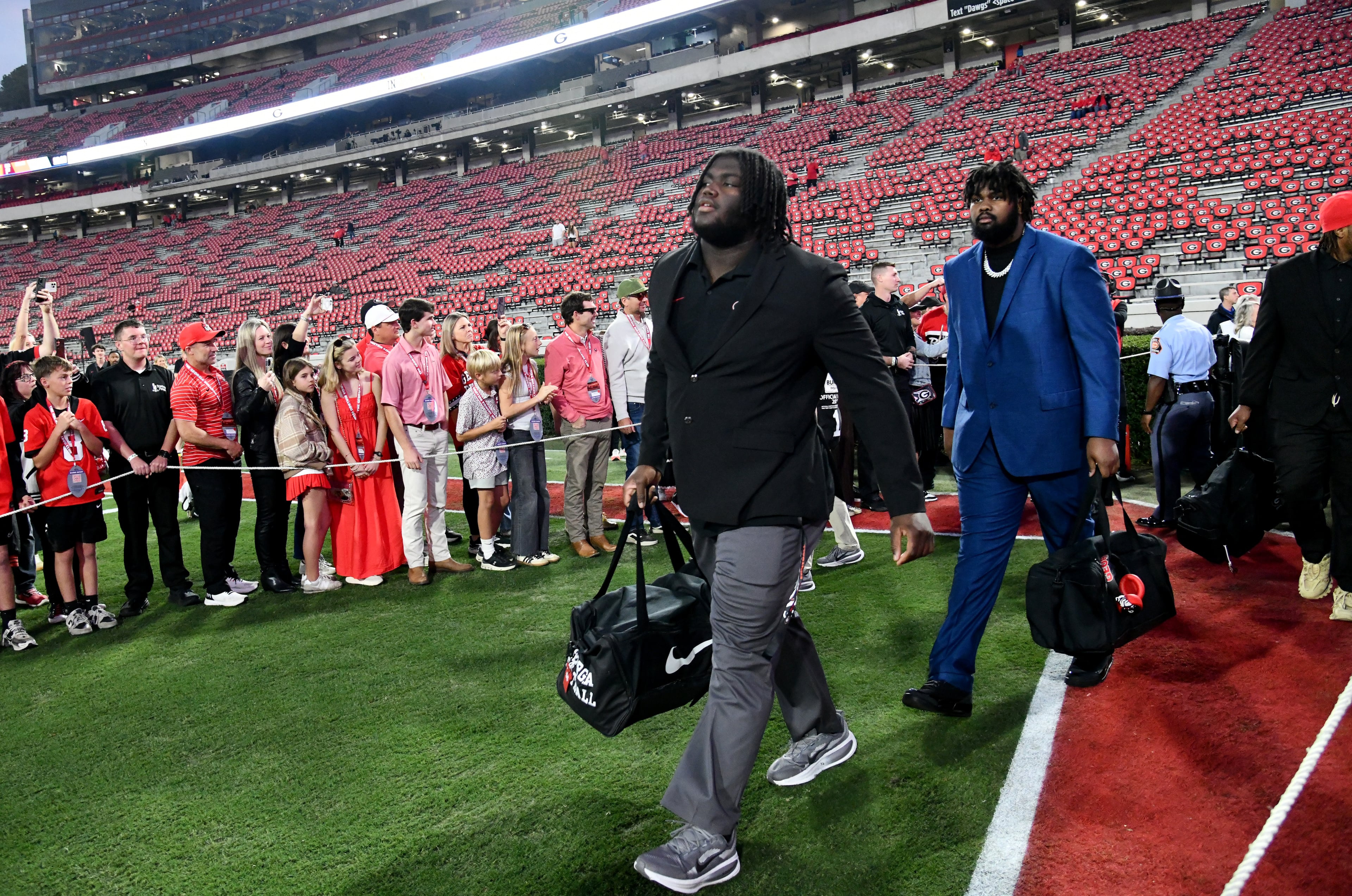 Georgia offensive lineman Micah Morris (left) and offensive lineman Juan Gaston Jr. arrive during Dawgs Walk before an NCAA football game between Georgia and Texas at Sanford Stadium, Saturday, November 15, 2025, in Athens. (Hyosub Shin / AJC)