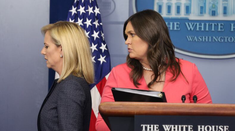 Homeland Security Secretary Kirstjen Nielsen, left, leaves the White House briefing room as press secretary Sarah Huckabee Sanders walks to the podium in this June 18 file photo. Oliver Contreras/Sipa USA/TNS