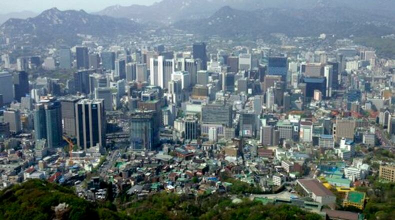 A city view is seen from the observation deck of Seoul Tower, South Korea. With the South Korean currency, called the won, down against the dollar, now's the time to wander the grounds of 600-year-old palaces, meditate in Buddhist temples and trawl cafes and markets in the labyrinthine capital city, Seoul.