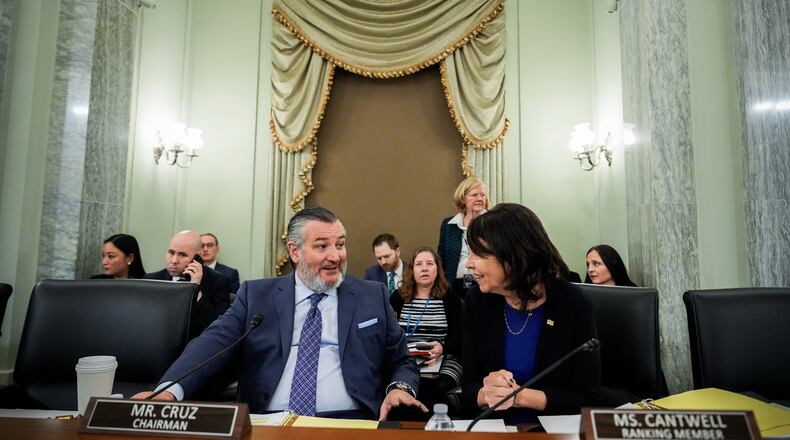 FILE - Sen. Ted Cruz, R-Texas, left, chairman of the Senate Commerce, Science and Transportation Committee, speaks with Sen. Maria Cantwell, D-Wash., right, before a hearing Wednesday, Nov. 19, 2025, on Capitol Hill in Washington. (AP Photo/Julia Demaree Nikhinson,File)