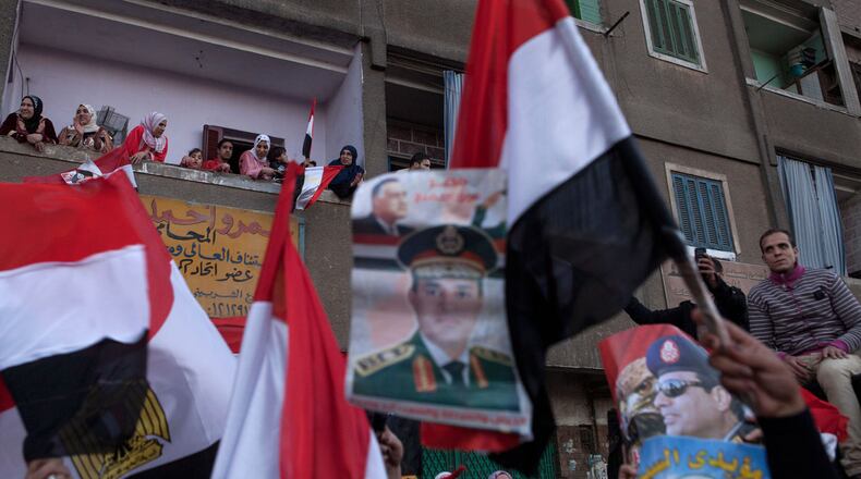 Supporters of Egyptian Defense Minister Abdel Fattah al-Sisi celebrate at the end of the second day of voting in Egypt's constitutional referendum in the Shubra district on January 15, 2014 in Cairo, Egypt. Egyptians went to the polls for a second day on Wednesday, after the first day of voting on Tuesday was marred by clashes between protesters and security forces, and one explosion at a courthouse, in the Egyptian capital Cairo. Egyptians voted in the referendum to decide on the third constitution for Egypt since the overthrow of former President Hosni Mubarak in February 2011. (Photo by Ed Giles/Getty Images).