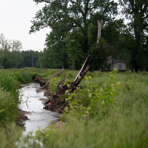 Water flows near homes in flood-prone Cahokia Heights, Ill., May 15, 2025. (AP Photo/Michael Phillis)