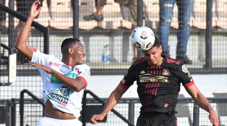 Atlanta United Miles Robinson (12) heads the ball over LD Alajuelense Junior Diaz (15) in the first half Tuesday, April 13, 2021, at Fifth Third Bank Stadium in Kennesaw. (Hyosub Shin / Hyosub.Shin@ajc.com)