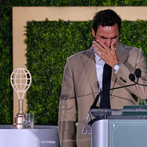 Roger Federer tries to hold back his tears during his induction ceremony at the International Tennis Hall of Fame, Saturday, Aug. 29, 2026, in Newport, R.I. (AP Photo/Charles Krupa)