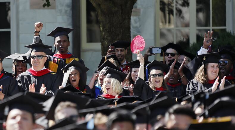 Emory University School of Theology graduates cheer as their degrees are conferred during the May 2019 commencement ceremony. Some international students there are experiencing delays getting permits to work internships. BOB ANDRES / BANDRES@AJC.COM