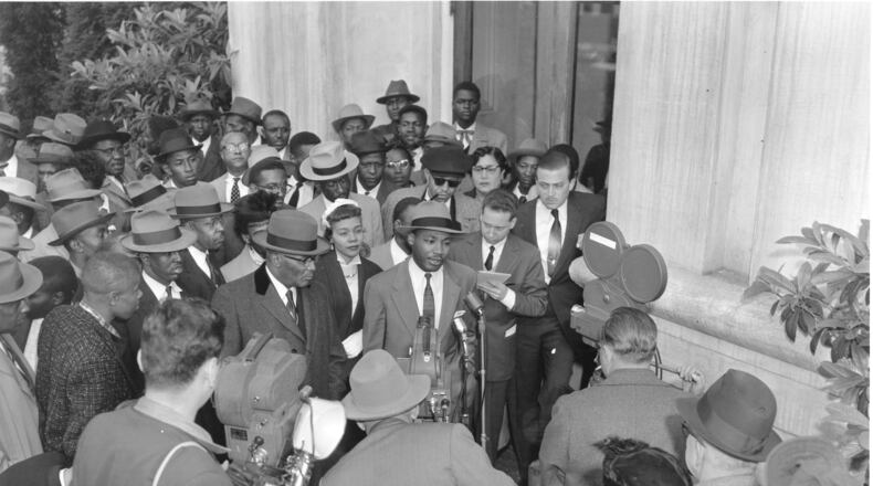 Following his arrest for leading the 1956 Montgomery bus boycott, the Rev. Martin Luther King, Jr., speaks to reporters. King, 26 years old at the time, and 92 others were charged with violation of Alabama's anti-boycott law. His arrest on income tax perjury charges came four years later. AP/Gene Herrick