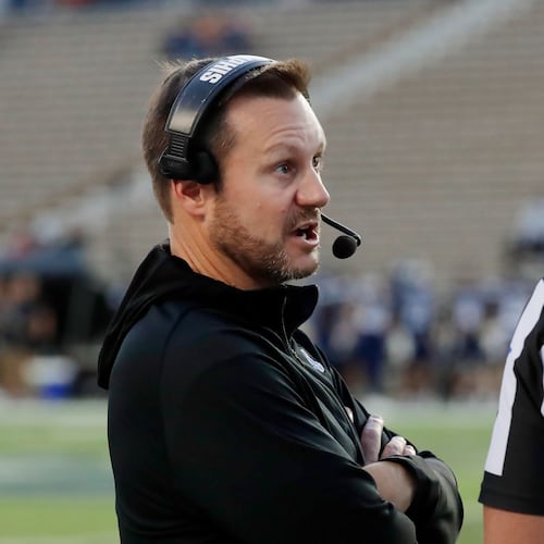 Memphis head coach Ryan Silverfield, left, talks with an official after a penalty during the first half of an NCAA college football game against Rice, Friday, Oct. 31, 2025, in Houston. (AP Photo/Michael Wyke)