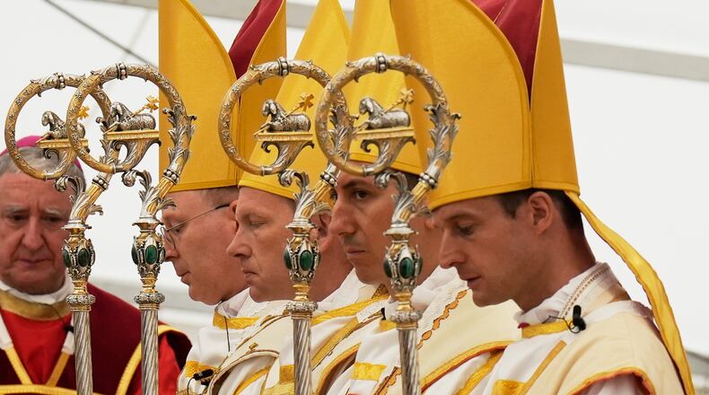 Newly consecrated bishops, from left, Pascal Schreiber, Michael Goldade, Michel Poinsinet de Sivry and Marc Hanappier, wearing their miters and holding their pastoral staffs, pray at the end of their consecration ceremony in a tent set up outside the Society of St. Pius X seminary in Econe, Switzerland, Wednesday, July 1, 2026. (AP Photo/Baz Ratner)