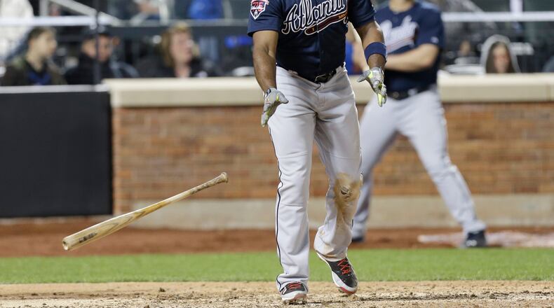 Justin Upton watches his three-run home in the top of the ninth inning. The Braves would need the insurance runs as the Mets rallied in the bottom of the ninth. (AP Photo/Frank Franklin II)