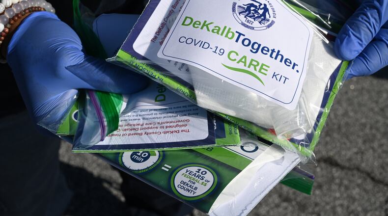 May 9, 2020 Decatur - DeKalb County police and fire cadets passed out COVID-19 care kits containing two non-surgical masks and hand sanitizer to residents to mitigate the spread of COVID-19 at Big Lots parking lot at 2738 Candler Road in Decatur on Saturday, May 9, 2020. DeKalb County Board of Health is supporting this initiative. (Hyosub Shin / Hyosub.Shin@ajc.com)