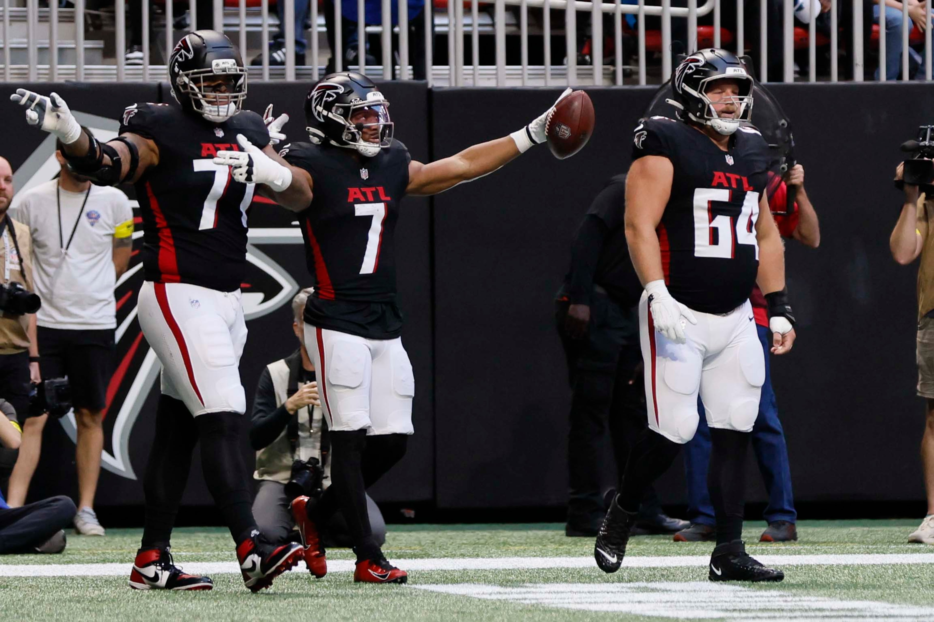 Atlanta Falcons running back Bijan Robinson (center) reacts after getting a first down during the first half of an NFL football game against the Carolina Panthers at Mercedes-Benz Stadium in Atlanta on Sunday, Nov. 16, 2025. (Miguel Martinez/AJC)
