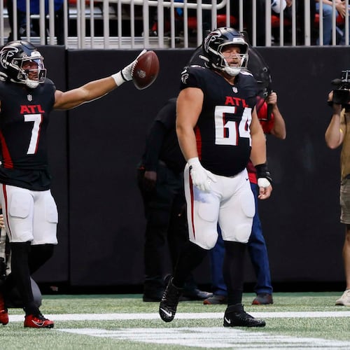 Falcons running back Bijan Robinson (center) reacts after a first down during against the Carolina Panthers at Mercedes-Benz Stadium on Sunday, Nov. 16, 2025. (Miguel Martinez/AJC)